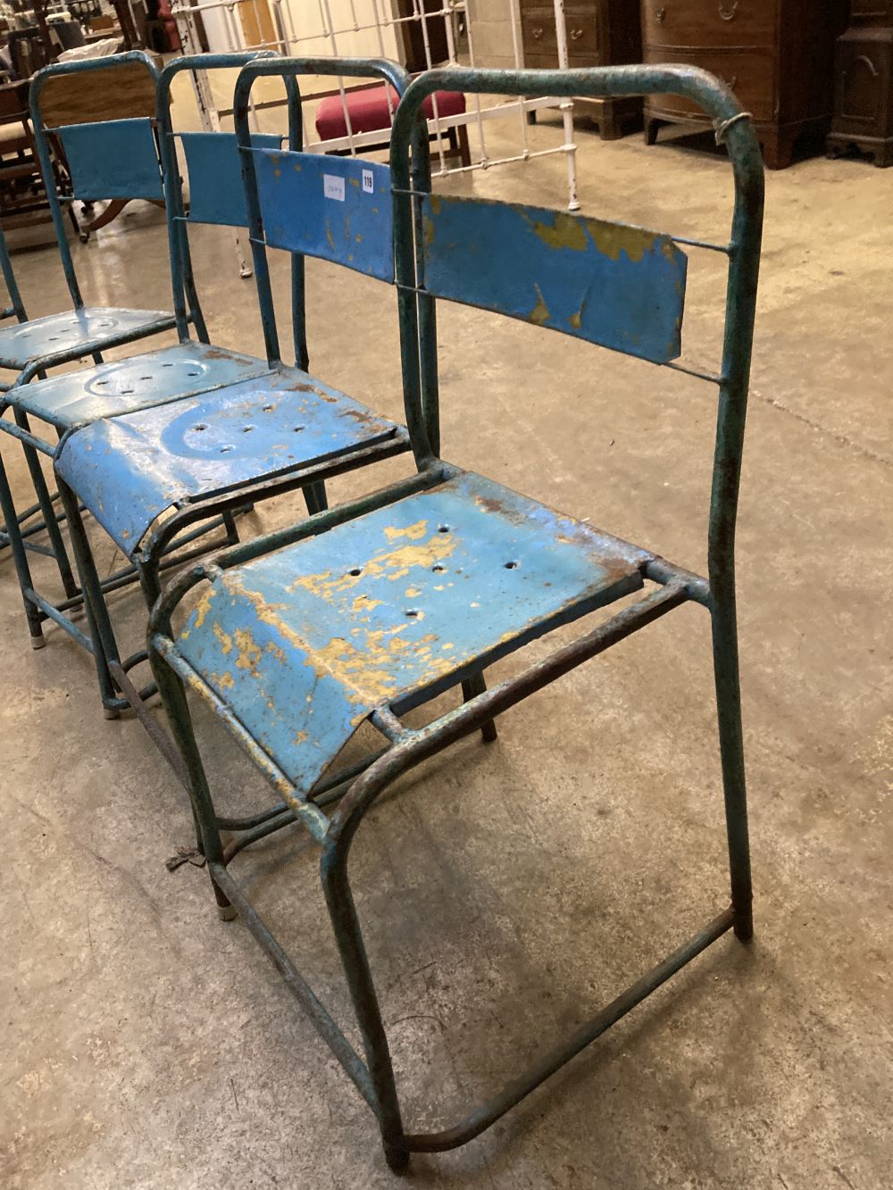 Four painted metal stacking chairs